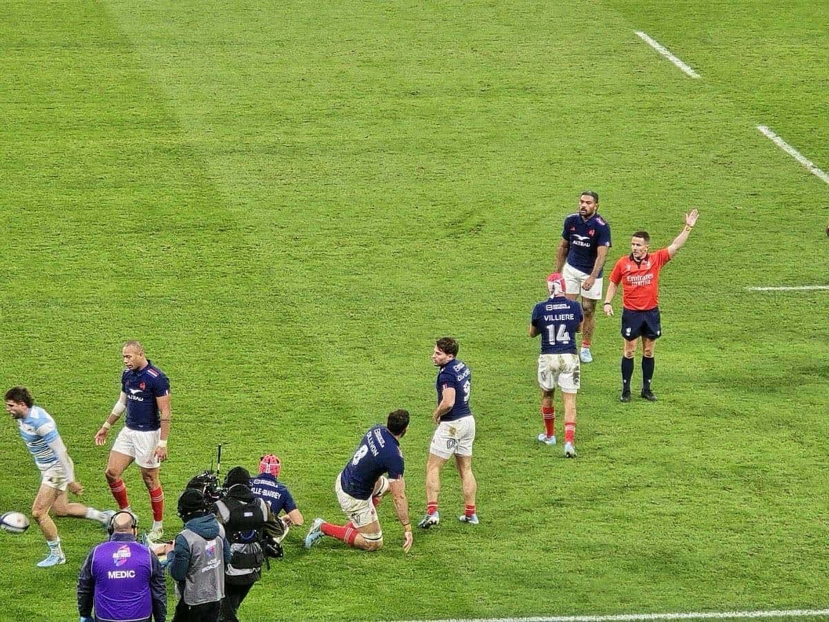 Foto de archivo: el árbitro levanta el brazo derecho en el Stade de France durante el Francia-Argentina de noviembre de 2024, con jugadores franceses de azul alrededor